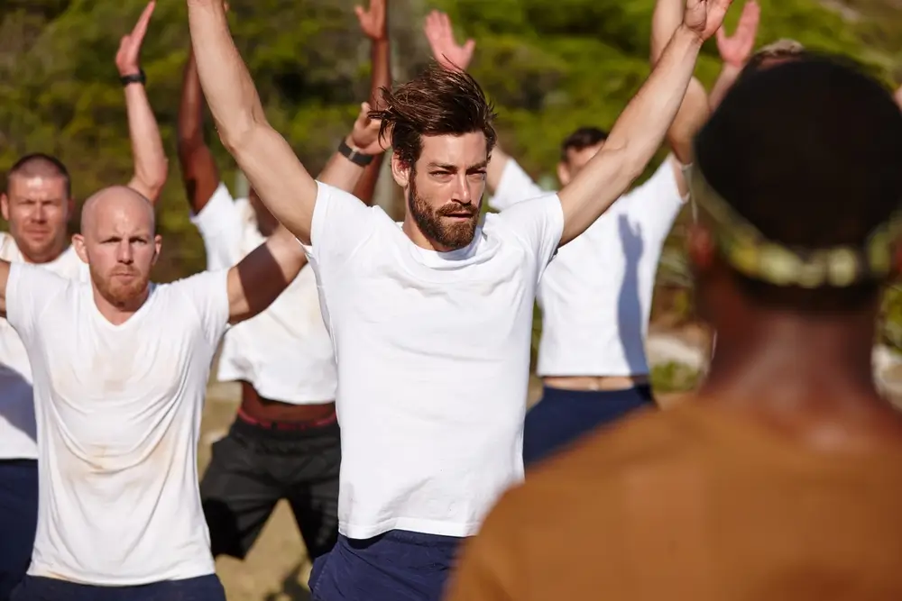 Bewerber absolvieren konzentriert Fitnessübungen im Freien als Vorbereitung auf den Sporttest der Bundeswehr.